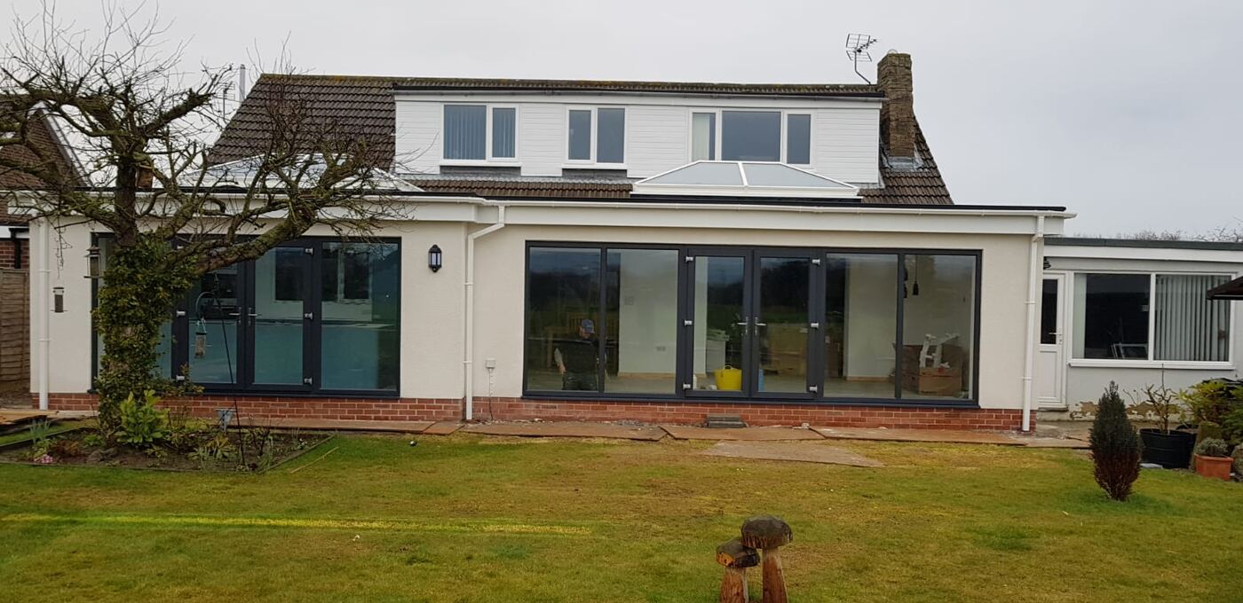 Gable fronted conservatory at dusk with lights on