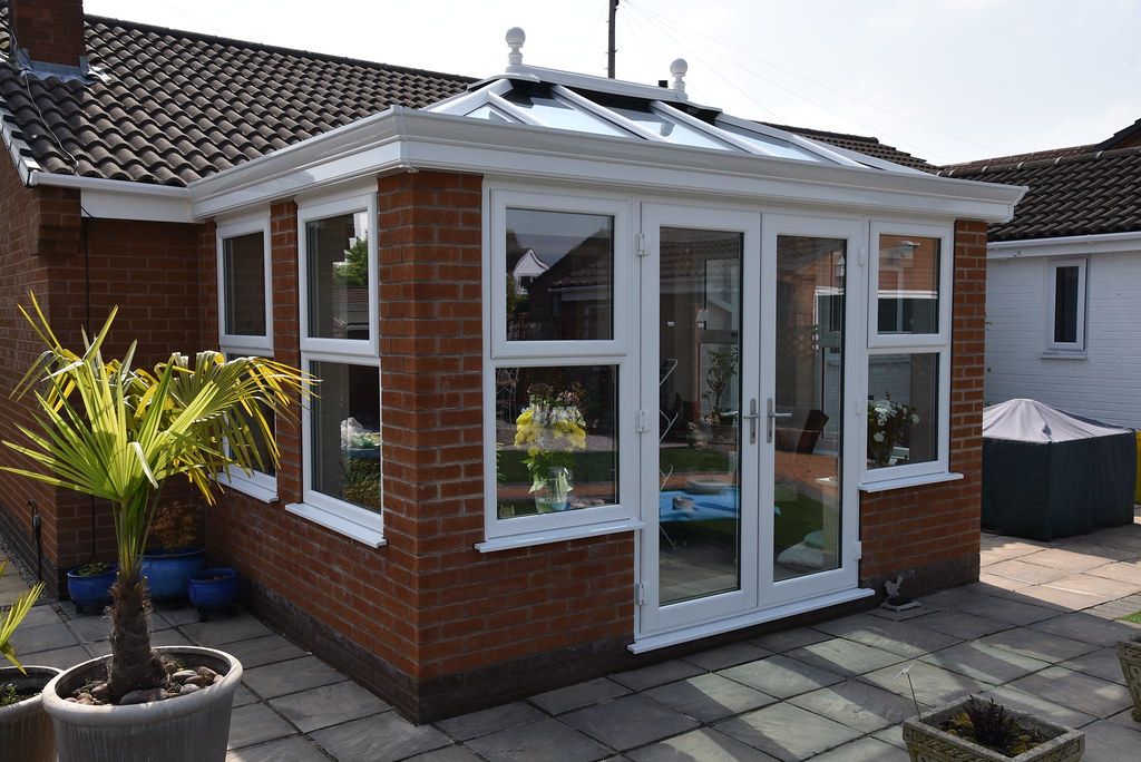 An orangery with solid pillars and a glazed lantern roof